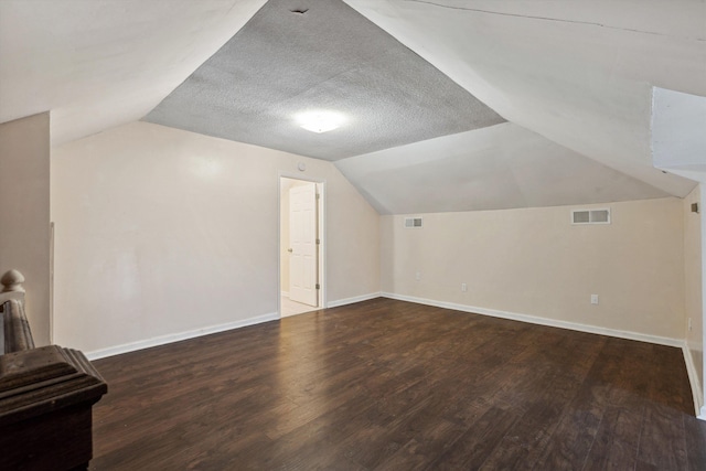 8457 Kerrville-Rosemark Rd, Millington, TN 38053 - additional living space with visible vents, baseboards, wood finished floors, and vaulted ceiling