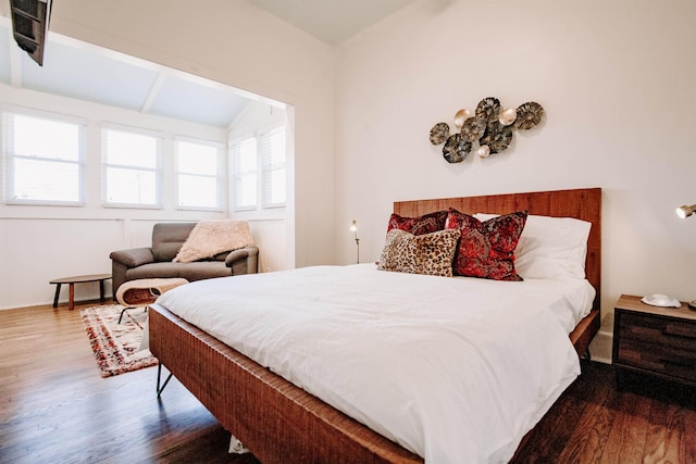 bedroom with vaulted ceiling and wood finished floors