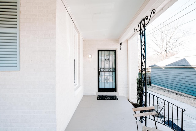 doorway to property featuring brick siding