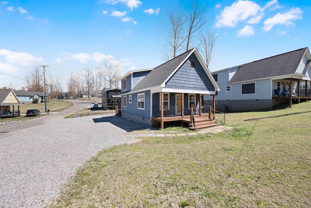 exterior space with gravel driveway, crawl space, a front lawn, roof with shingles, and covered porch