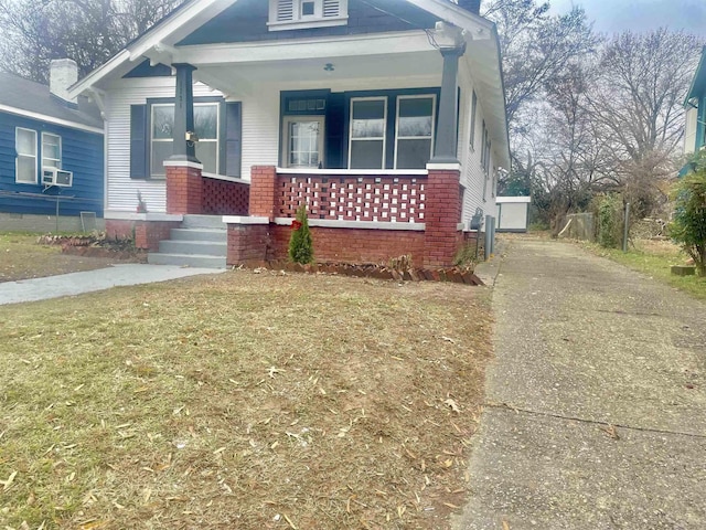 1131 Rozelle St, Memphis, TN 38106 - view of front facade featuring a front lawn, covered porch, and brick siding