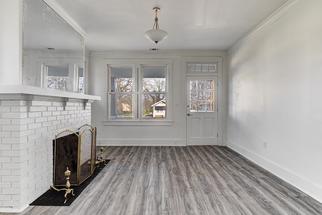 1131 Rozelle St, Memphis, TN 38106 - unfurnished living room featuring visible vents, crown molding, a brick fireplace, baseboards, and wood finished floors