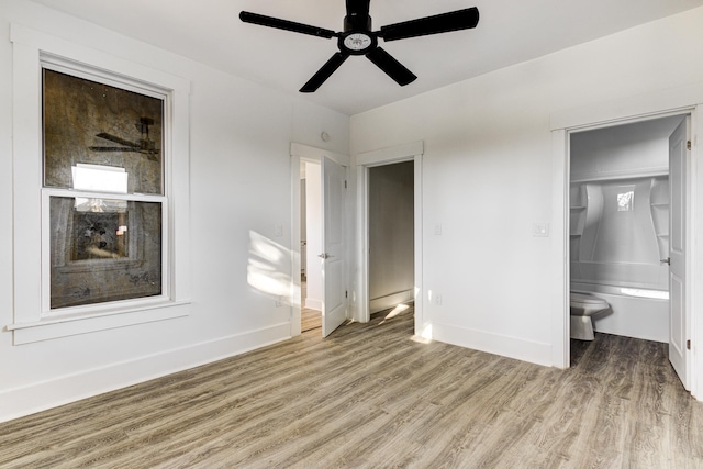 1131 Rozelle St, Memphis, TN 38106 - unfurnished bedroom featuring baseboards, ceiling fan, ensuite bathroom, and light wood-style floors