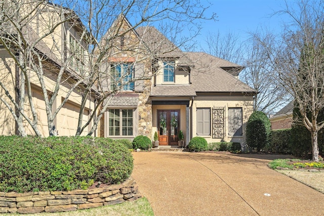 view of front of property featuring roof with shingles and french doors