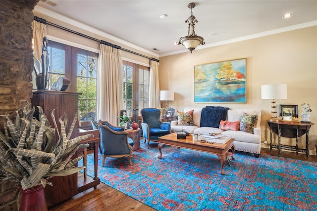 living area with french doors, visible vents, recessed lighting, wood finished floors, and ornamental molding