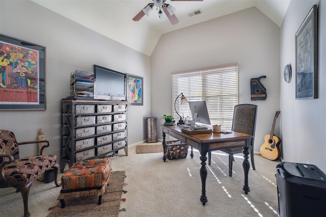 carpeted home office with vaulted ceiling, a ceiling fan, visible vents, and baseboards