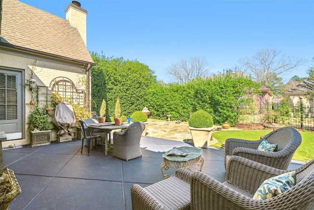 view of patio / terrace featuring outdoor dining space and fence