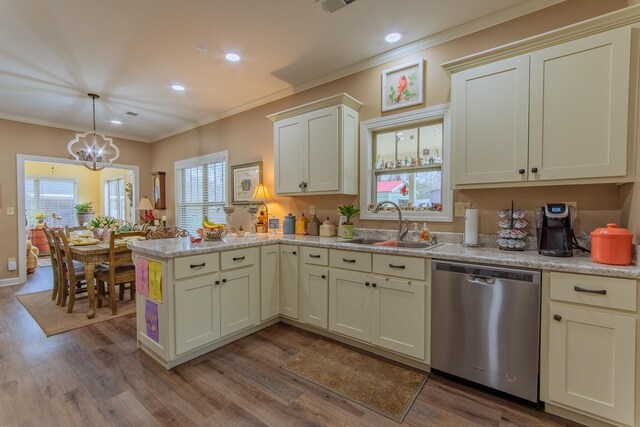 kitchen featuring a sink, dishwasher, a peninsula, ornamental molding, and an inviting chandelier
