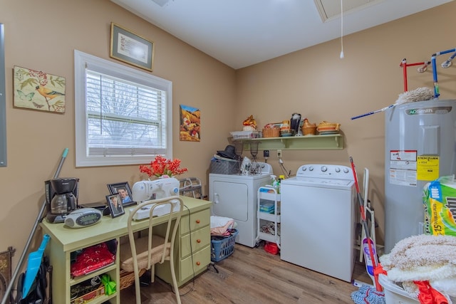 laundry room with wood finished floors, laundry area, attic access, electric water heater, and separate washer and dryer
