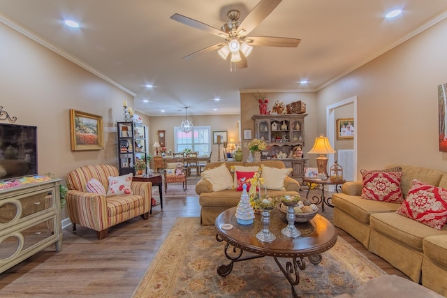 living room with recessed lighting, ornamental molding, ceiling fan, and wood finished floors