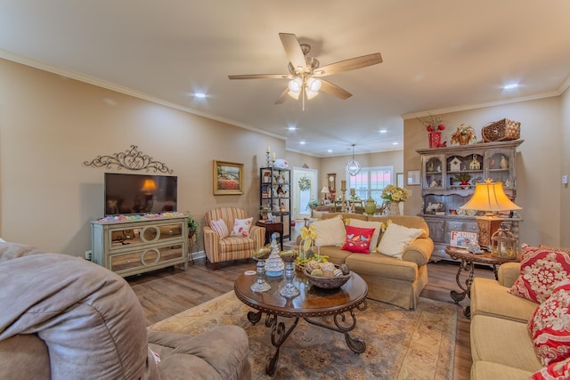 living area featuring ornamental molding, wood finished floors, recessed lighting, and a ceiling fan