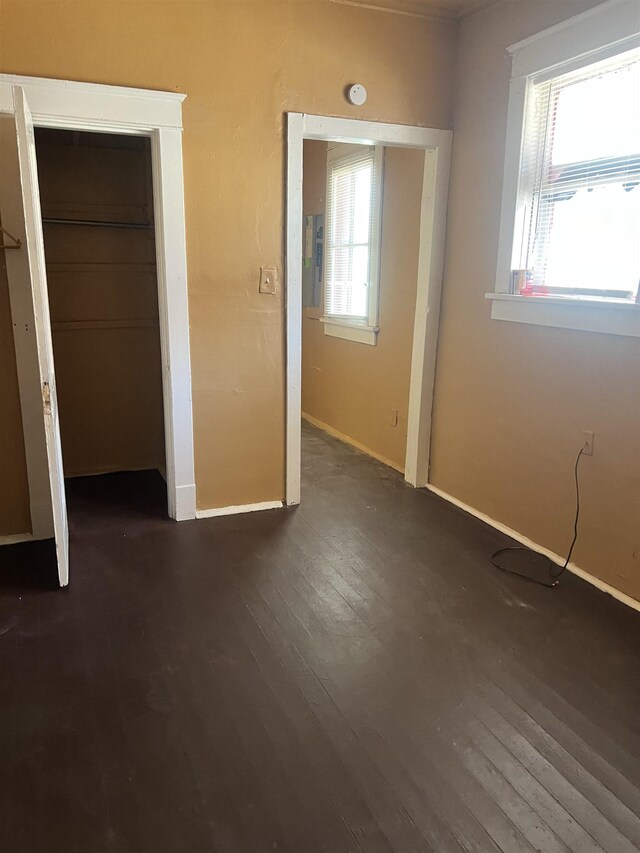 1535 Southern Ave, Memphis, TN 38114 - unfurnished bedroom with dark wood-style flooring, baseboards, and a closet