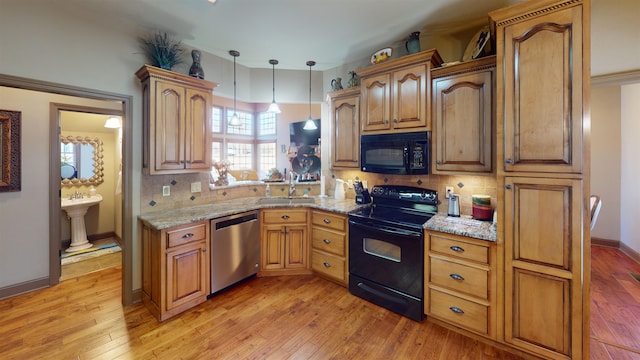 100 Carefree Ln, Counce, TN 38326 - kitchen with black appliances, light wood-style flooring, and a sink