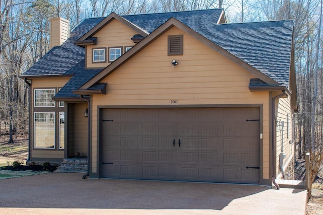 100 Carefree Ln, Counce, TN 38326 - view of front facade featuring roof with shingles, a garage, driveway, and a chimney