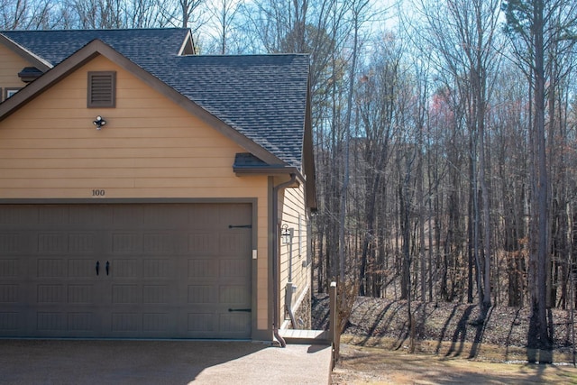 100 Carefree Ln, Counce, TN 38326 - view of side of home with roof with shingles and a garage