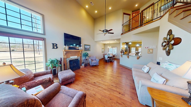 100 Carefree Ln, Counce, TN 38326 - living area with a healthy amount of sunlight, light wood-type flooring, ceiling fan, visible vents, and a high ceiling