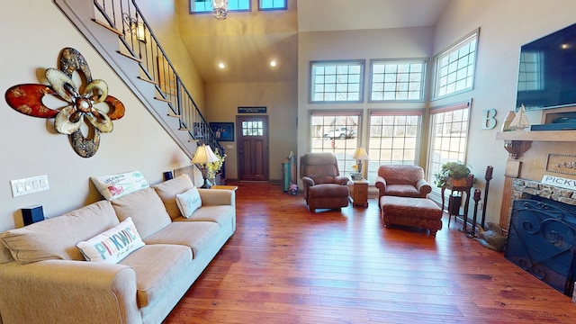 100 Carefree Ln, Counce, TN 38326 - living area featuring a fireplace, hardwood / wood-style floors, stairs, and a high ceiling