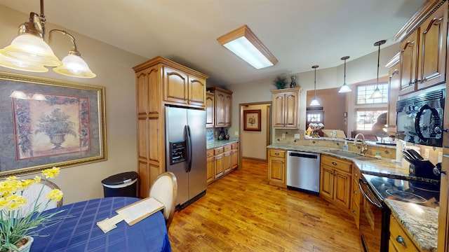 100 Carefree Ln, Counce, TN 38326 - kitchen featuring pendant lighting, decorative backsplash, a sink, black appliances, and light wood finished floors