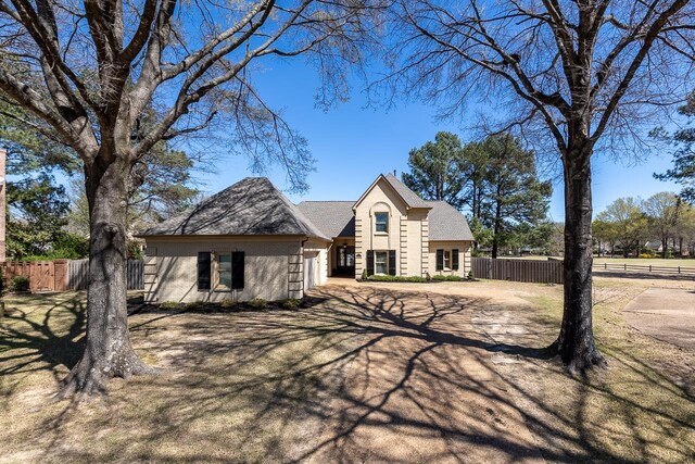 view of front of house with an attached garage and fence