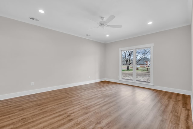spare room featuring light wood-type flooring, recessed lighting, baseboards, visible vents, and a ceiling fan