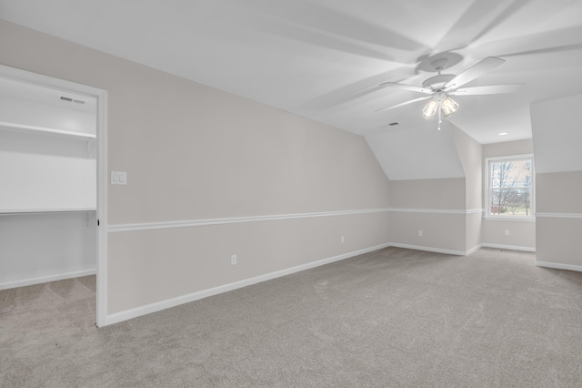 bonus room featuring a ceiling fan, lofted ceiling, baseboards, visible vents, and carpet