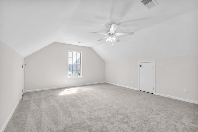 additional living space featuring carpet flooring, lofted ceiling, visible vents, and ceiling fan