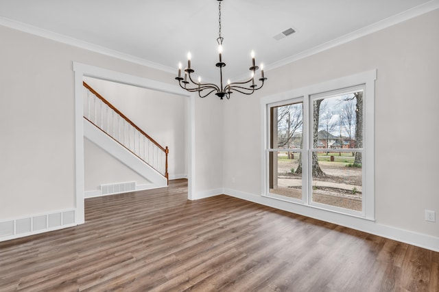 unfurnished dining area with ornamental molding, visible vents, and an inviting chandelier