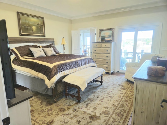 bedroom featuring access to outside, crown molding, and wood finished floors