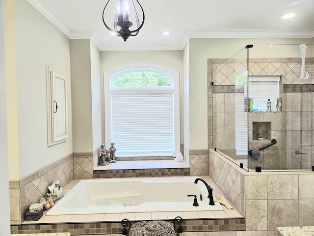 bathroom with a stall shower, crown molding, and a garden tub