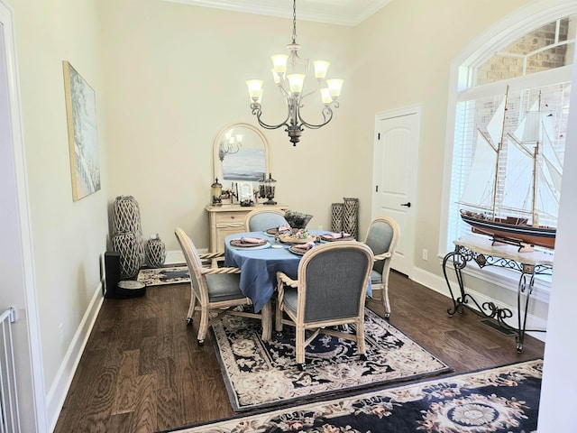 dining space featuring dark wood-type flooring, ornamental molding, baseboards, and a notable chandelier