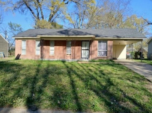 3240 Mario St, Memphis, TN 38127 - ranch-style house featuring driveway, a front yard, and a carport