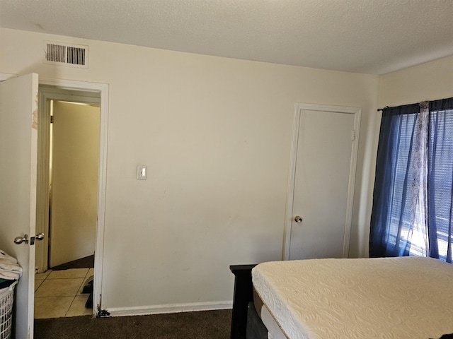 3240 Mario St, Memphis, TN 38127 - bedroom with tile patterned flooring, a textured ceiling, baseboards, and visible vents