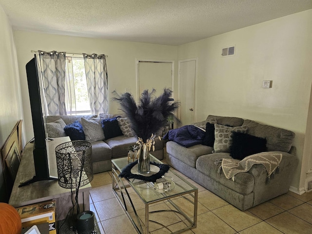 3240 Mario St, Memphis, TN 38127 - tiled living room with a textured ceiling and visible vents