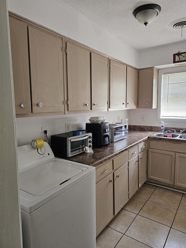 3240 Mario St, Memphis, TN 38127 - washroom featuring a textured ceiling, visible vents, washer / clothes dryer, laundry area, and light tile patterned floors