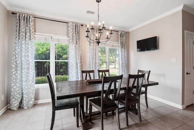 dining space featuring crown molding, baseboards, a chandelier, and visible vents