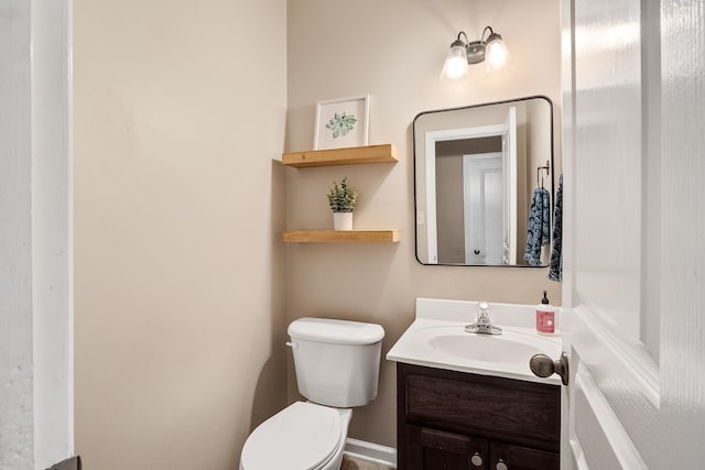 bathroom with toilet and vanity