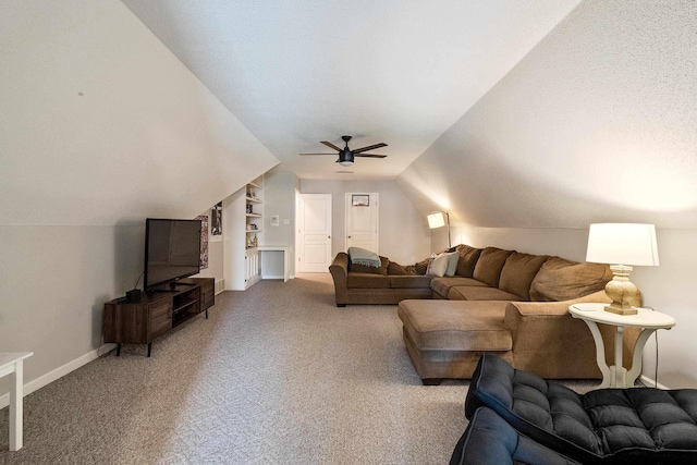 carpeted living room featuring baseboards, lofted ceiling, and ceiling fan