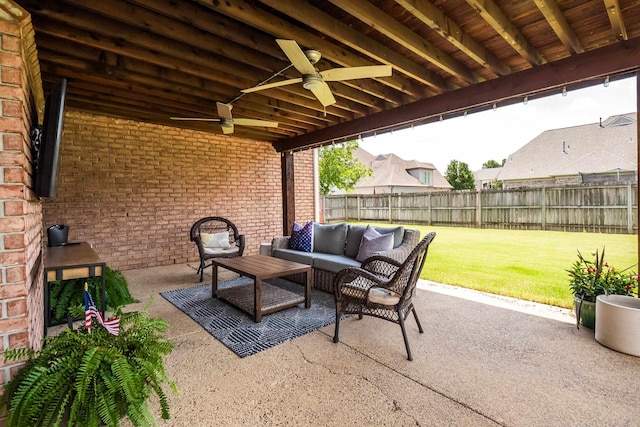 view of patio / terrace with outdoor lounge area, a fenced backyard, and a ceiling fan