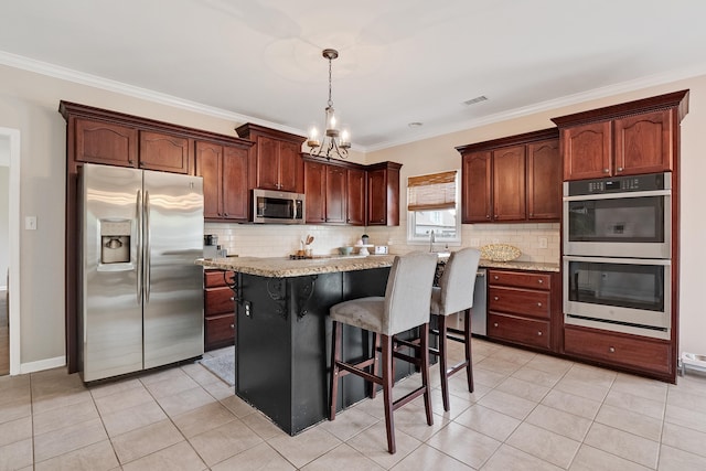 kitchen with light tile patterned flooring, a chandelier, backsplash, and stainless steel appliances