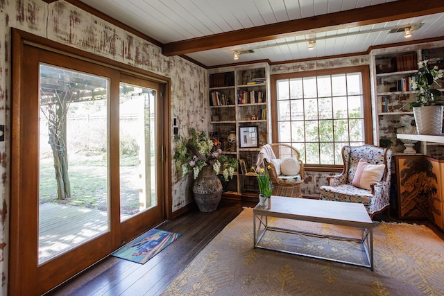 sitting room featuring hardwood / wood-style floors, built in features, and beamed ceiling
