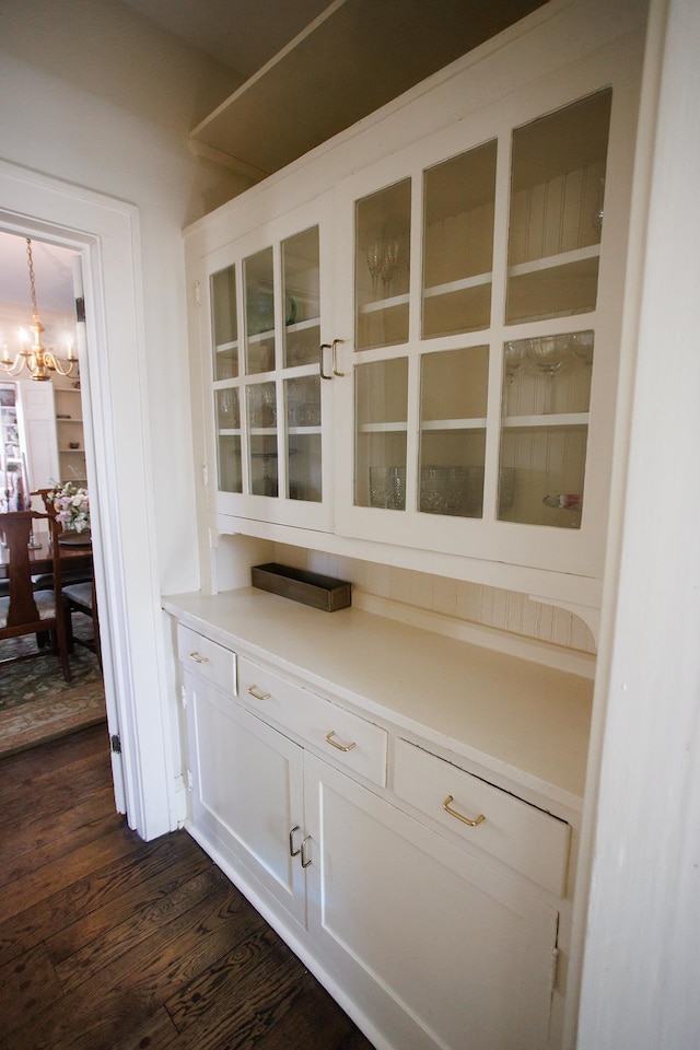details with a notable chandelier and wood finished floors