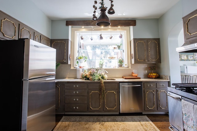 kitchen featuring light countertops, dark brown cabinets, appliances with stainless steel finishes, ventilation hood, and backsplash