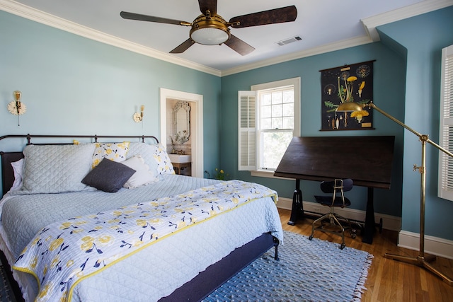 bedroom featuring visible vents, baseboards, ornamental molding, ceiling fan, and wood finished floors