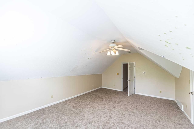 bonus room featuring carpet floors, lofted ceiling, baseboards, and a ceiling fan