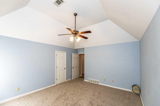 unfurnished bedroom featuring lofted ceiling, visible vents, carpet flooring, and baseboards