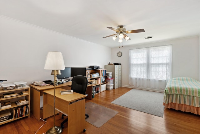 office area with visible vents, crown molding, wood finished floors, and a ceiling fan