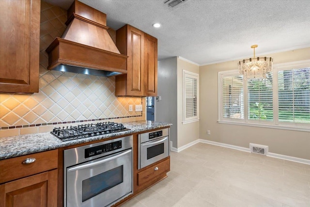 2060 Abergeldie Dr, Memphis, TN 38119 - kitchen with gas stovetop, visible vents, premium range hood, and oven