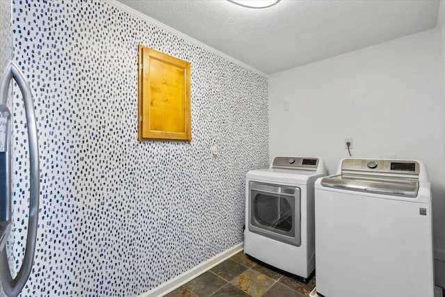 2060 Abergeldie Dr, Memphis, TN 38119 - laundry area featuring a textured ceiling, stone finish floor, ornamental molding, laundry area, and washer and clothes dryer