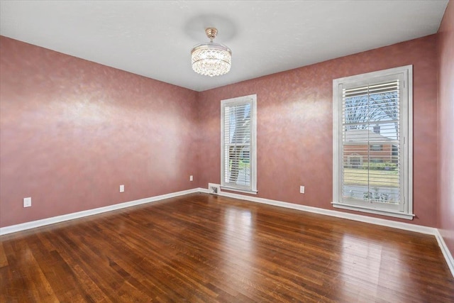 2060 Abergeldie Dr, Memphis, TN 38119 - spare room featuring baseboards, a notable chandelier, visible vents, and wood finished floors