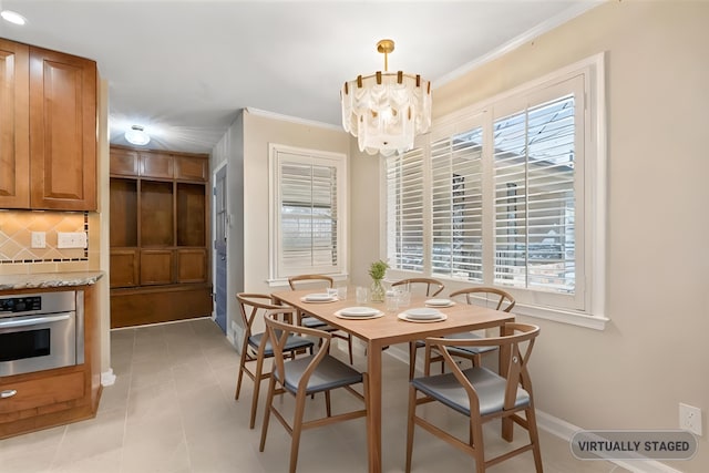 2060 Abergeldie Dr, Memphis, TN 38119 - dining area with baseboards, light tile patterned floors, crown molding, and a notable chandelier